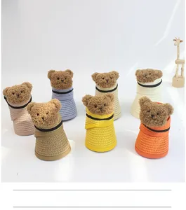 Detail view of woven bear visors in seven colors including khaki, pink and yellow