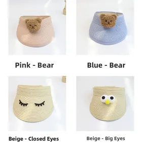 Detail view of children's straw sun visors with cute bear and embroidery patterns