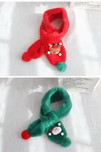 Detail of red and green plush Christmas scarves with elk and Santa Claus cartoon heads