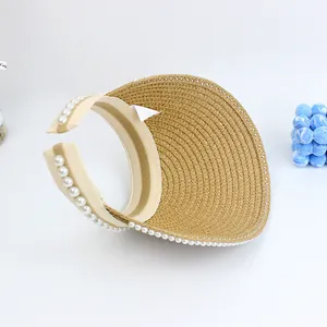 Detailed macro view of woven sun hat with pearl trim and inner sweatband