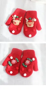 Detailed view of red knitted Christmas mittens with 3D reindeer and snowflake motifs