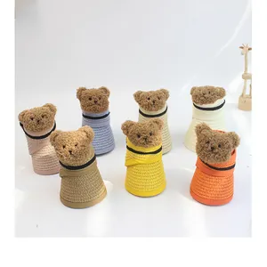Detailed view of kids straw sun visors with cartoon bears in multiple colors