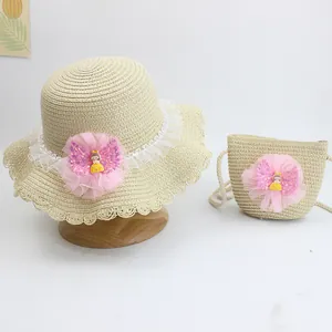 Detail of beige straw hat and matching bag set with lace and pink mesh floral accents