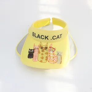 Detailed top view of kids yellow sun hat with cartoon black cat prints and side wings