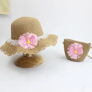 Detail view of straw sun hat and matching bag with lace trim and mesh flower decor