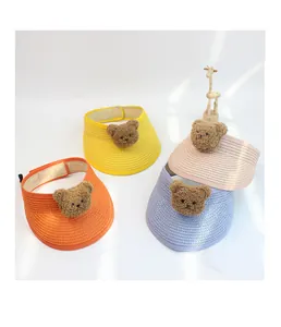 Detail of colorful children straw visors with plush bear and adjustable velcro strap