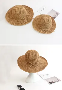Detail of hand-woven straw hat set for women and kids with bow tie decorations