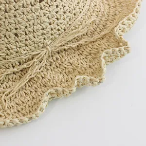 Beige handwoven straw sun hat with wavy brim and decorative rope for women and kids