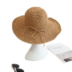 Handwoven wide brim straw sun hat for women featuring a stylish bow and natural texture