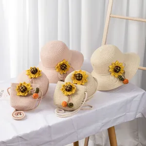 Detail of summer straw sun hat and matching crossbody bag with sunflower accents