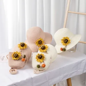 Detailed view of children straw sun hat and matching crossbody bag with sunflower accents
