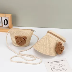 Close-up of kids summer straw sun visor and matching bear crossbody bag set