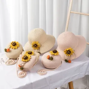 Detail of straw sun hats and matching crossbody bags with sunflower and pompom accents