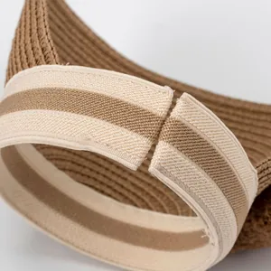 Detail view of straw sun hat back with elastic striped band for adjustable fit