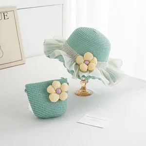 Close-up of mint green straw hat and bag set with yellow fabric flowers and lace