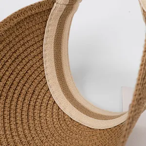 Detail of children's straw sun hat showing inner weave texture and beige sweatband