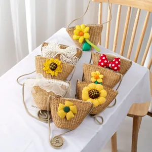 Detail of handmade straw crossbody bags with sunflowers and lace for children