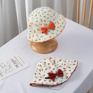 Detail of floral baby sun hats with bow accents and elastic windproof chin straps