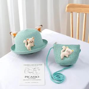 Detail of mint green straw hat and bag set with 3D ears and cartoon cat patch