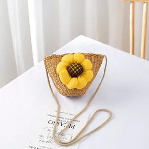 Detail of hand-woven straw bag for girls featuring a yellow fabric sunflower accent