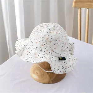 Detail of floral baby sun hat with ruffled brim and soft cotton crinkle texture