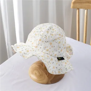 Close-up of floral baby sun hat fabric featuring breathable texture and wave brim detail