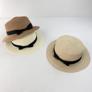 Detailed weave of flat top straw sun hats with black ribbon bow in three colors