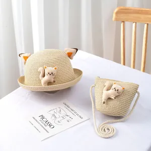 Kids beige straw sun hat and matching crossbody bag set with cute 3D cat ears and plush toy