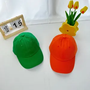 Kids vibrant green and orange cotton baseball caps for summer sun protection