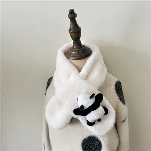 Detail of white plush scarf with cute panda doll on wooden mannequin with polka dot top