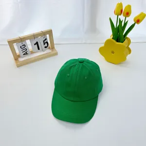 Macro shot of bright green cotton baseball cap with curved brim on minimalist background