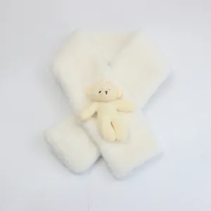 Detailed view of plush beige faux rabbit fur scarf featuring a 3D cute teddy bear ornament