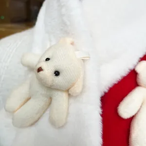 Detail of white plush faux rabbit fur scarf with a cute teddy bear doll ornament