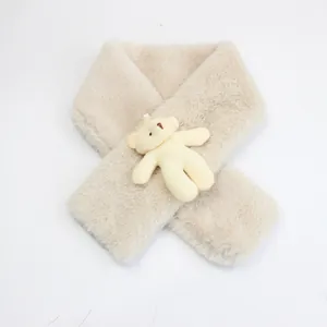 Close-up of beige faux rabbit fur winter scarf with a cute 3D plush bear detail
