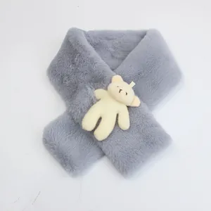 Detail of grey faux fur kids scarf with a beige plush bear and cross-over closure