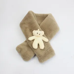 Detail of soft faux rabbit fur scarf with a cute teddy bear plush toy attachment