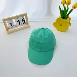 Close-up of mint green cotton baseball cap with detailed stitching and breathable eyelets