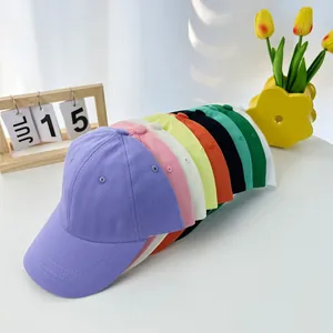 Close-up of vibrant cotton baseball caps in multiple colors stacked on a clean desk