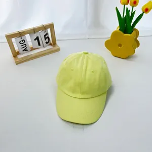Detailed view of yellow cotton baseball cap with reinforced brim and uniform stitching