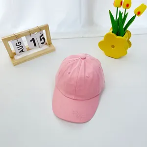 Detailed close-up of pink cotton baseball cap with ventilation eyelets on top