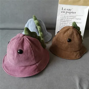 Detailed corduroy texture and 3D dinosaur crest on children's bucket hats in three colors
