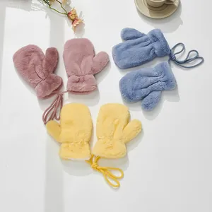 Detailed close-up of fluffy kids mittens with anti-lost lanyards in blue, pink, and yellow