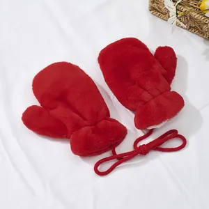 Detail of red plush kids mittens with warm lining and convenient neck string