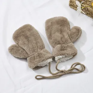 Detail of coffee brown plush mittens with lanyard and thick faux fur lining texture