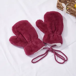 Detail of burgundy plush mittens with white fleece lining and convenient neck string