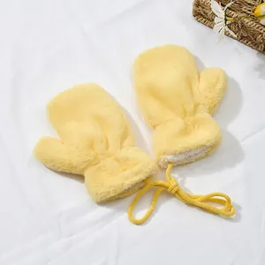 Detail of yellow plush baby mittens with fleece lining and anti-lost neck string