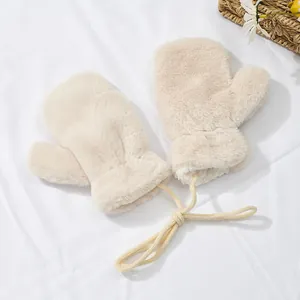 Detail of plush cream faux rabbit fur mittens with warm lamb wool lining and neck strap