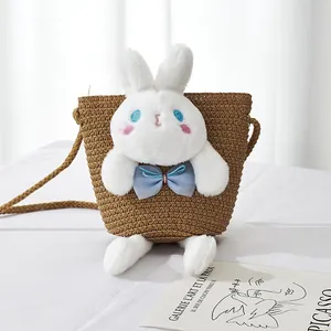 Handwoven straw bucket bag for girls with a cute plush rabbit and woven strap