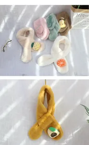 Detail of plush children's scarves with 3D fruit patches in various vibrant colors