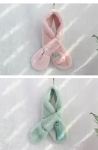 Detail of plush children's winter scarf with strawberry decor and cross-fastening